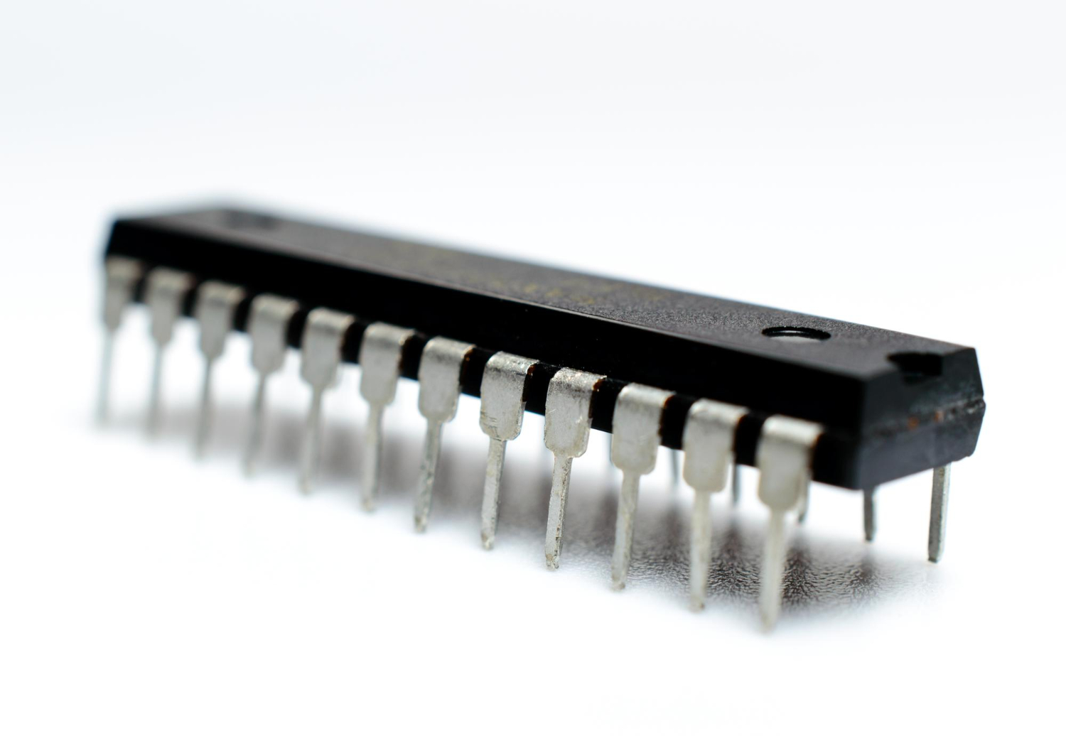 black-microchip-with-metal-legs-white-background-microcircuit-silicon-chip-macro-photo